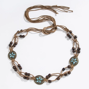 Detail of bohemian brown woven waist chain with dark wooden beads and blue gemstone charms