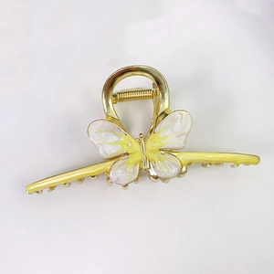 Elegant gold metal butterfly hair claw clip with yellow enamel details for women