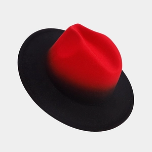 Detailed texture of red and black gradient wool felt fedora with a smooth finish