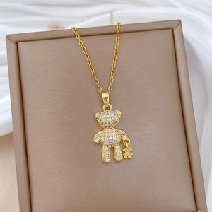 Detailed macro view of gold teddy bear pendants fully encrusted with sparkling rhinestones