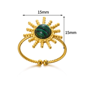Detail showing a 15mm sun-shaped gold ring with green malachite stone and braided band