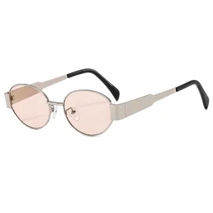 Vintage oval metal sunglasses with silver frame and light orange lenses on white background