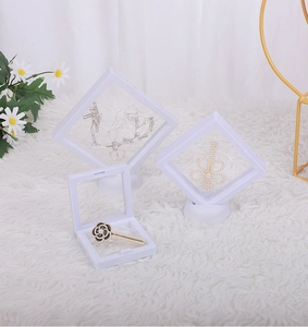 White PE film floating jewelry display frame with round base on white fur background