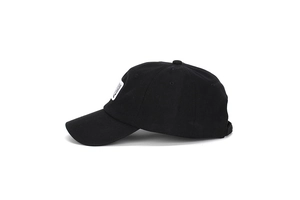 Detail view of cotton baseball cap with square logo patch and adjustable strap