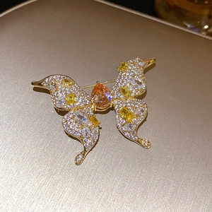 Macro detail of a vintage golden butterfly brooch with colorful zircons and rhinestones