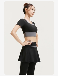 Detail of black sports set featuring high-waist skirt leggings and cropped top with grey trim