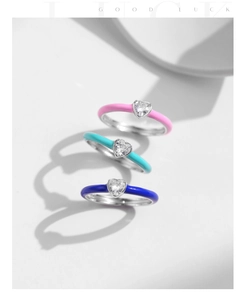 Close-up of three colorful S925 silver heart rings with vibrant enamel and zircon inlays