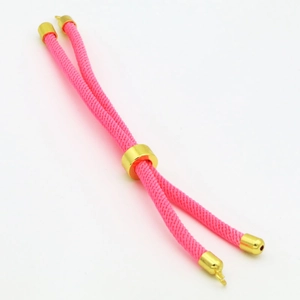 Detailed view of pink woven cord with adjustable gold metal slider and end caps for DIY