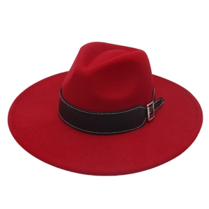 Detail of red wool fedora hat featuring a black leather belt and silver metal buckle
