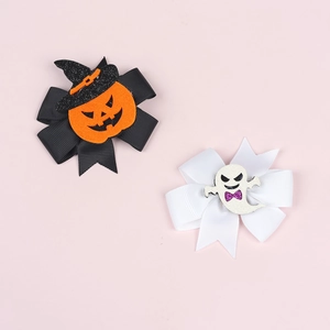 Detail of Halloween bow hair clips with glittery pumpkin, witch hat and ghost designs
