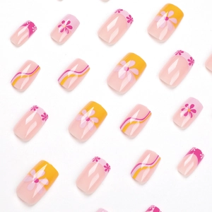 Pink and yellow floral press-on nails with French tips and wave pattern designs