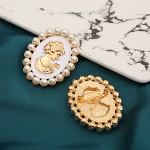 Vintage gold cameo brooch with pearl trim and female profile relief on silk background