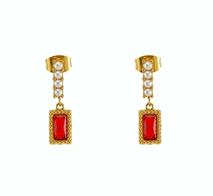 Close-up of vintage gold earrings with red rectangle stones and elegant pearl details