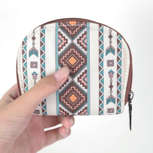 Detail of canvas coin purse with geometric tribal patterns and secure zip closure