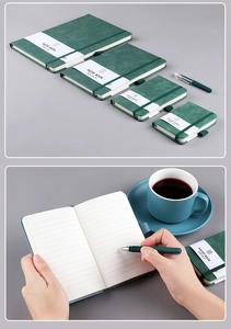 Close-up of green PU leather notebook with elastic band and soft lined pages