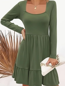 Close-up of the layered ruffle hem and flowing fabric of the moss green A-line dress