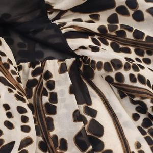 Detail of abstract leopard print fabric with lightweight chiffon texture and draping
