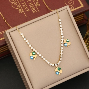 Golden clover necklace with evil eye enamel charms and sparkling rhinestones in jewelry box