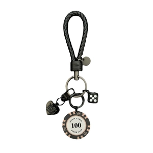 Braided leather keychain with Poker chip, heart charm and dice on white background