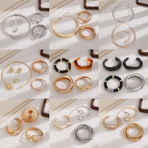 Detailed grid view of minimalist gold and resin jewelry sets with necklaces and earrings