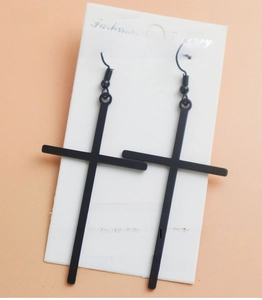 Detail of matte black long cross earrings with gothic hook style and vintage finish