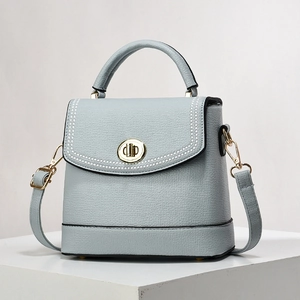 Light blue lychee texture handbag with gold twist lock and white perforated details