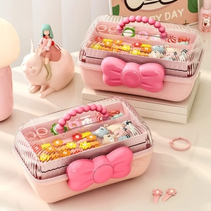 Close-up of a pink bow jewelry organizer with double-layer storage and transparent lid