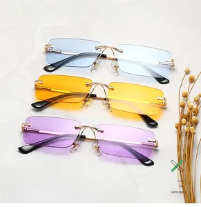 Close-up of three rimless rectangular sunglasses in blue, yellow, and purple with gold temples