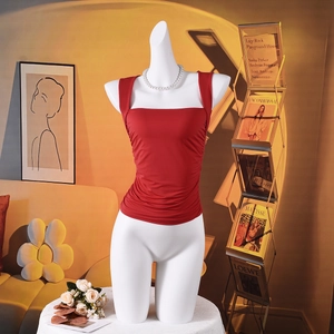 Close-up of red square-neck sleeveless top with ruching details and pearl necklace accessory