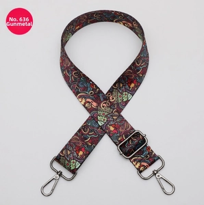 Detail of colorful ethnic pattern adjustable bag strap with gunmetal swivel hooks