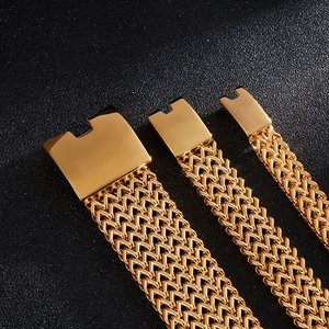 Three assorted sizes of gold stainless steel Cuban link bracelets on black background