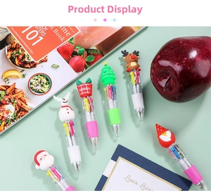 Detailed close-up of Christmas 4-color ballpoint pens with cartoon Santa and elk toppers