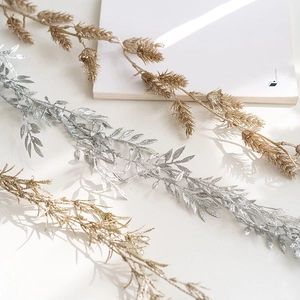 Artificial Christmas vine garlands in champagne, silver and gold for festive decoration
