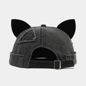 Detail of grey washed denim docker hat featuring fox ears and adjustable metal buckle