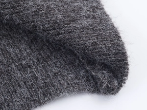 Macro view of dark grey knit fabric with soft texture and rich fibrous wool feel