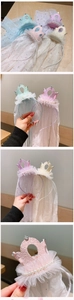 Detail of girls' crown headbands with star pattern veils in pink, blue, and beige colors