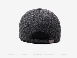 Detail view of the herringbone wool texture and adjustable metal buckle on a winter cap
