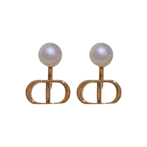 Elegant gold letter D earrings with round pearls in a minimalist luxury style for women