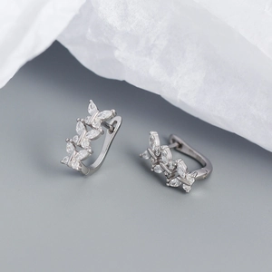Detail of silver leaf branch earrings with marquise-cut crystals and hinged back closure
