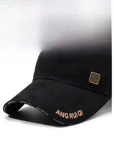 Detail of black baseball cap brim with gold embroidery and metal logo branding