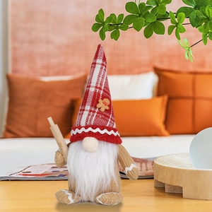 Close-up of Christmas gnome plush featuring a red checkered hat and a small wooden rolling pin