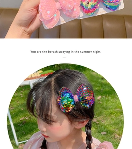 Close-up of large pink and rainbow sequin bow hair clips with glitter texture for girls