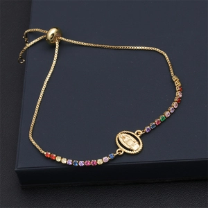 Detail of adjustable gold slider bracelet with Virgin Mary pendant and colorful zircons