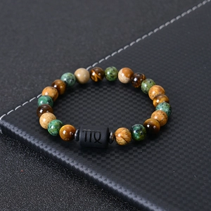 Macro shot of natural tiger eye stone beaded bracelet with black Virgo symbol bead