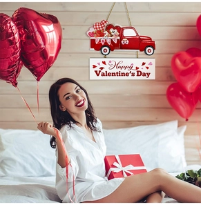 Detail of Valentine's wooden red truck sign and Happy Valentine's Day banner on the wall