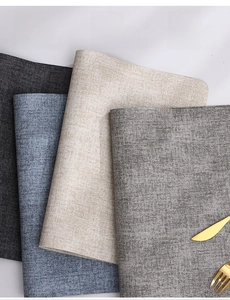 Close-up of waterproof faux leather placemats with dual-sided texture and durable finish
