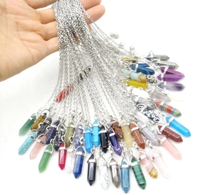 Macro view of various hexagonal crystal stone pendants with fine silver link chains