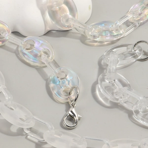 Close-up of iridescent acrylic chain links with metal lobster clasp detail