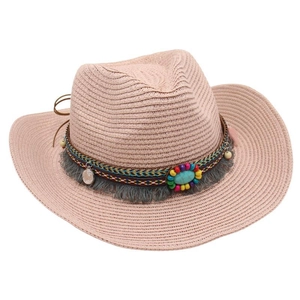 Detail of pink straw cowboy hat with bohemian beadwork and tassel trim decorations