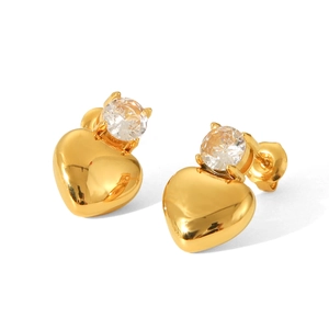 Close-up of golden heart earrings with sparkling round zirconia on a white background